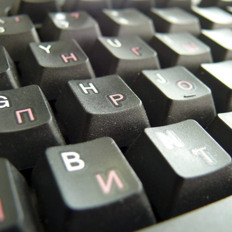 Nahaufnahme einer Tastatur mit schwarzen Tasten und weißen Buchstaben.