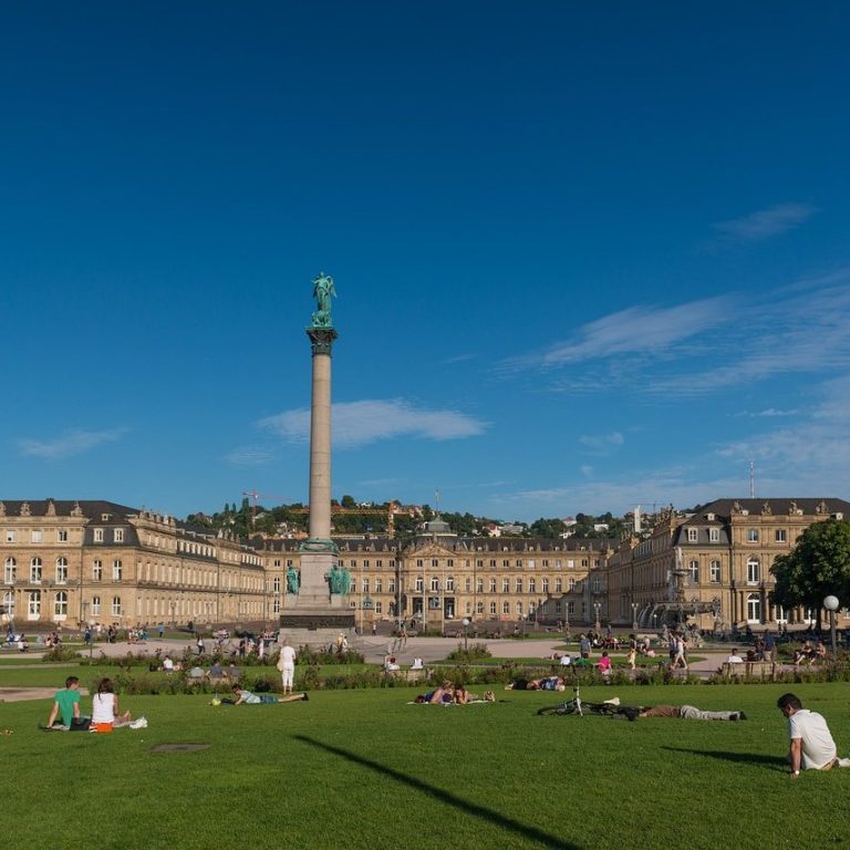 Blick auf das Schlossplatz in Stuttgart mit monumentalem Säule und grünem Rasen.